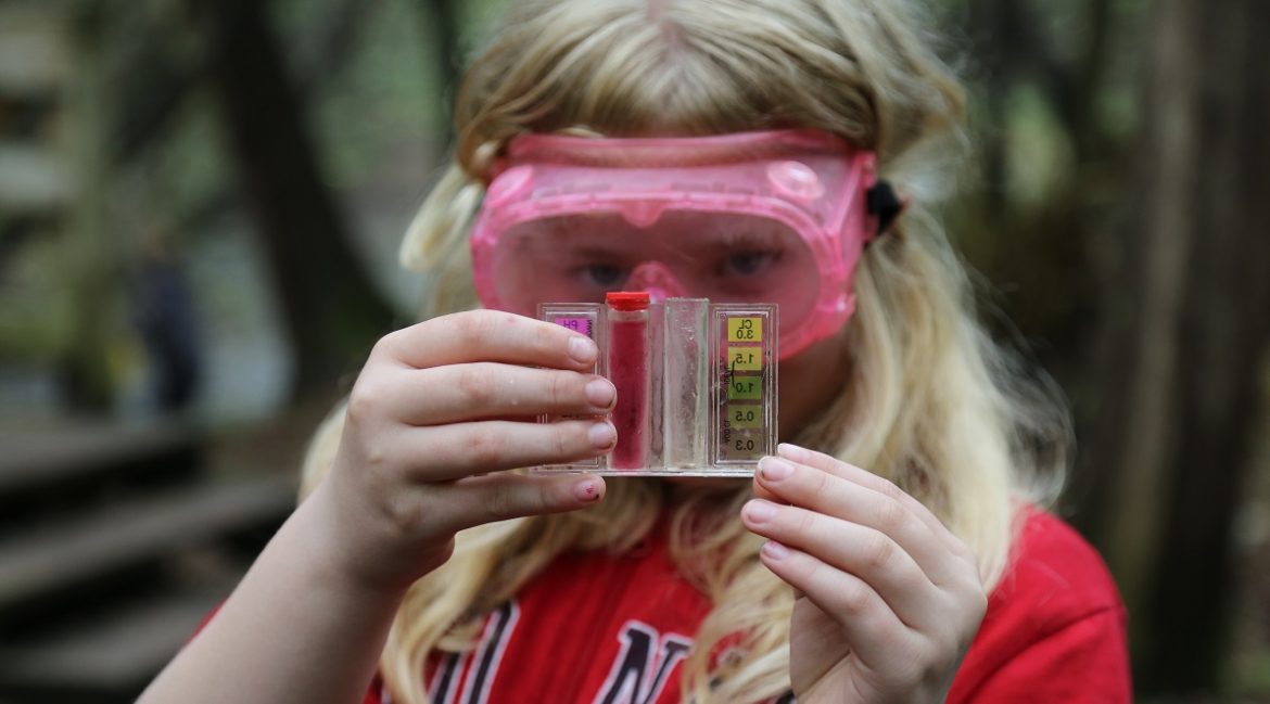 Grade 6 student conducting water quality study at Claremont Field Centre